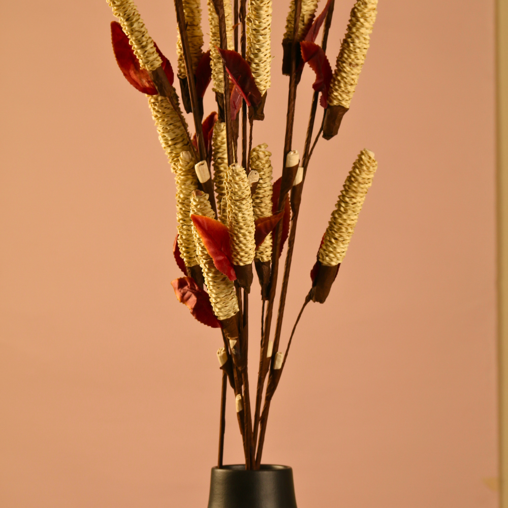 Dried golden pine chain bunch with black vase