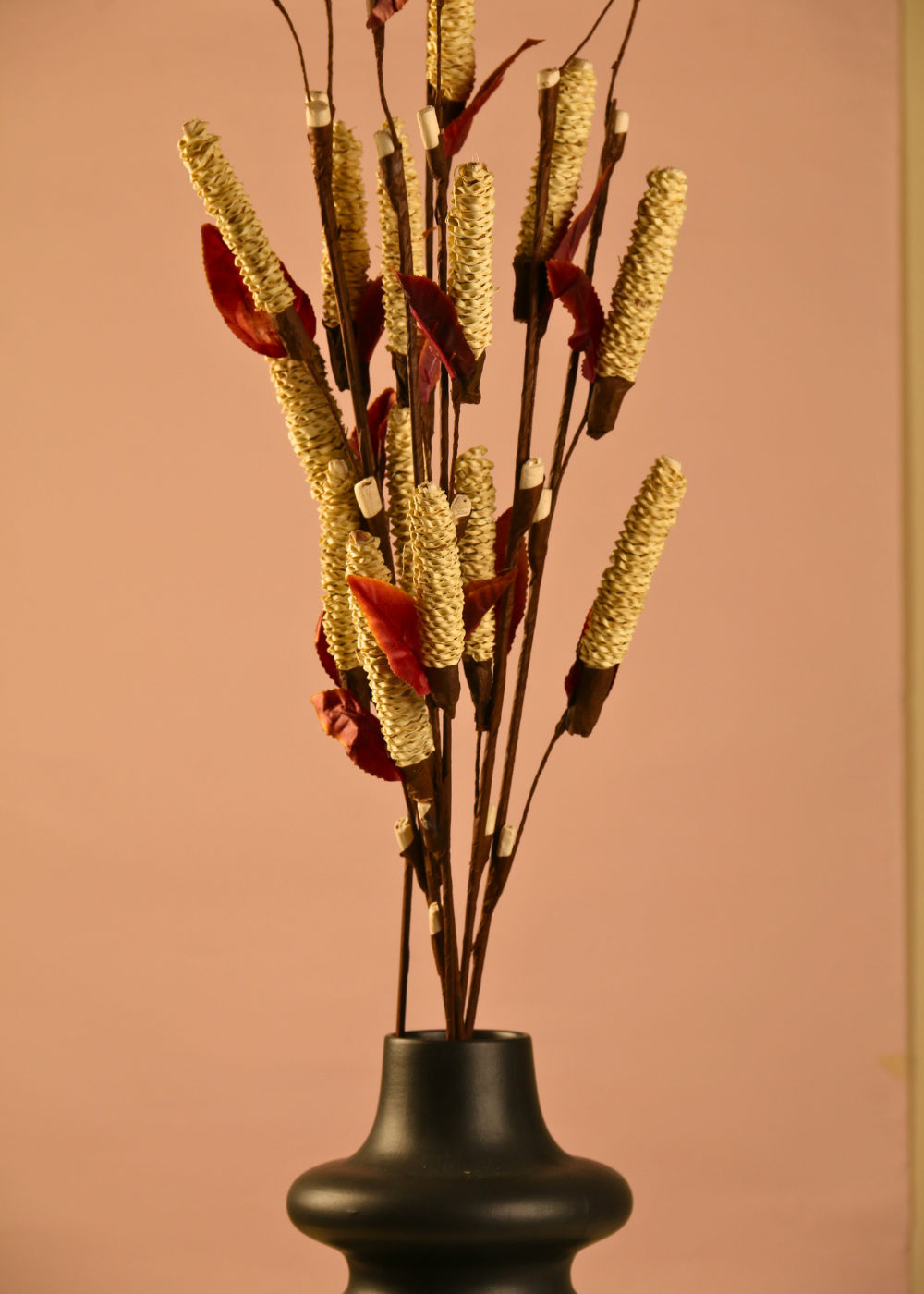 Dried golden pine chain bunch with black vase