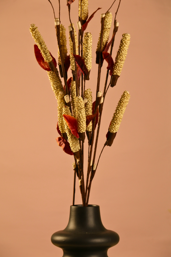 Dried golden pine chain bunch with black vase