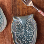 Owl spoon rest green on wooden surface