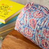 Block printed toiletry bag on a wooden surface