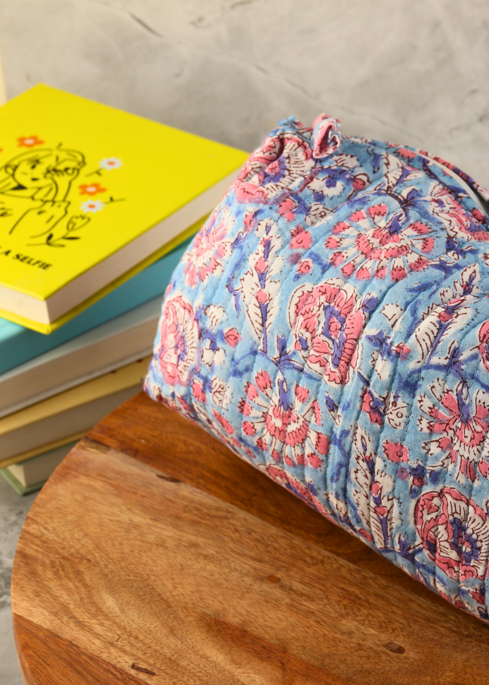 Toiletry bag block printed on a wooden surface