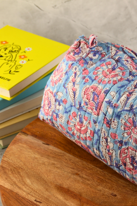Toiletry bag block printed on a wooden surface