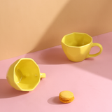 pink & yellow mug made by ceramic 