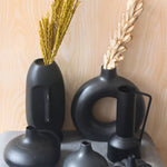 black vases made by ceramic 