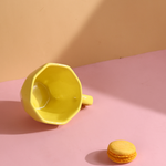 Yellow coffee mug with yellow macarons