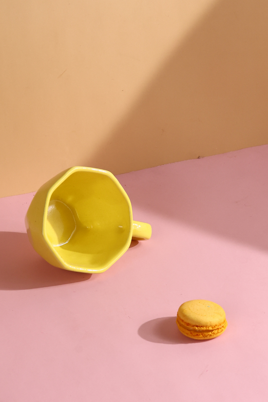 Yellow coffee mug with yellow macarons