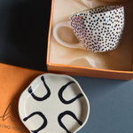 Black polka coffee mug & abstract dessert plate 