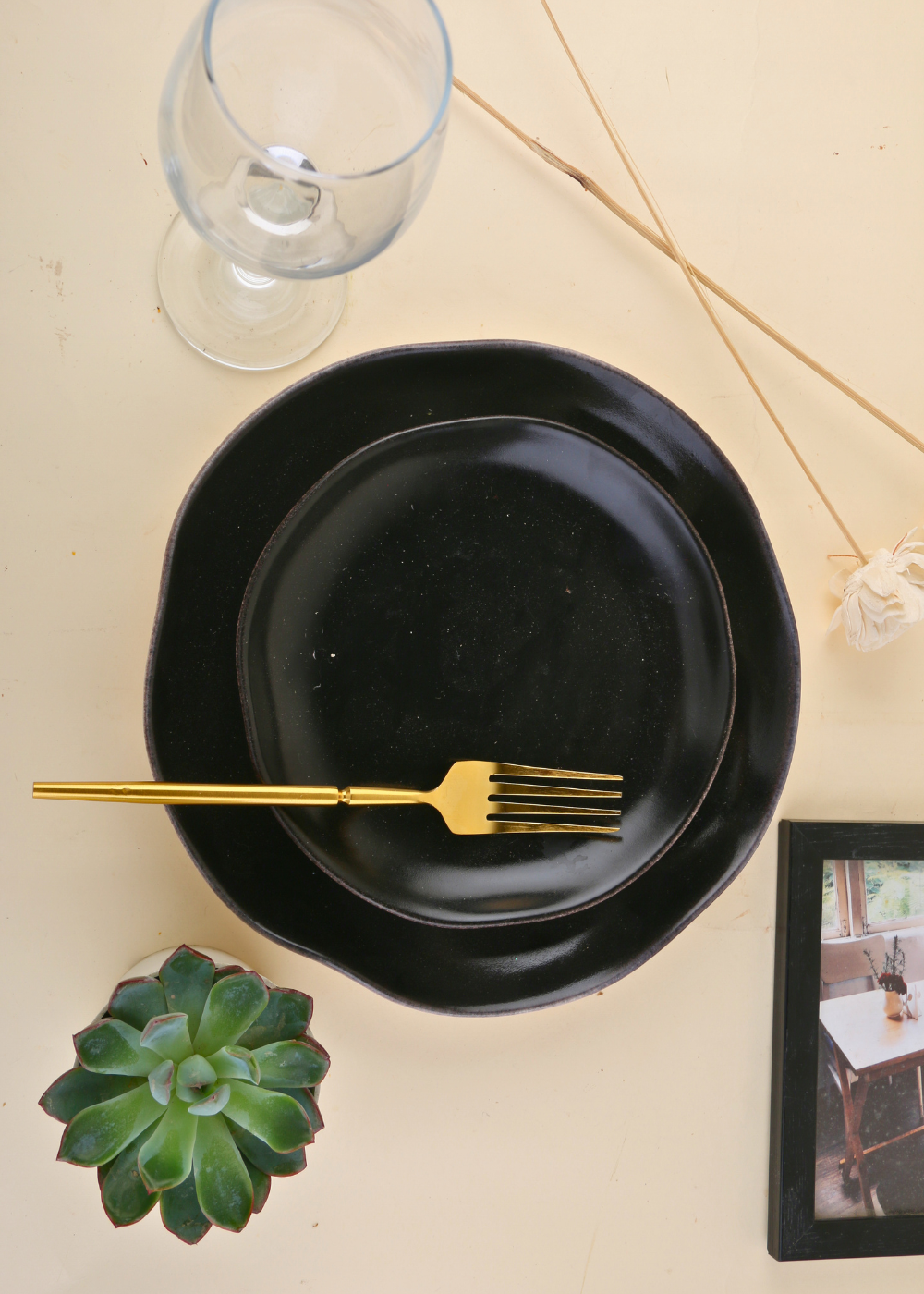 Golden fork on black plate