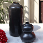 Two black flower vases - tall & moulded 