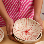 White bowl with red lines design 