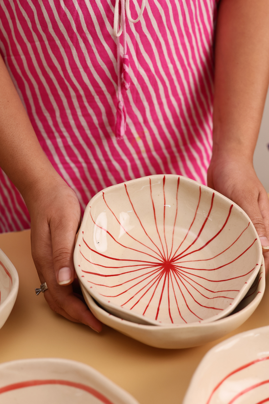 White bowl with red lines design 