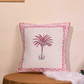 Pink and white cushion cover with palm print on it