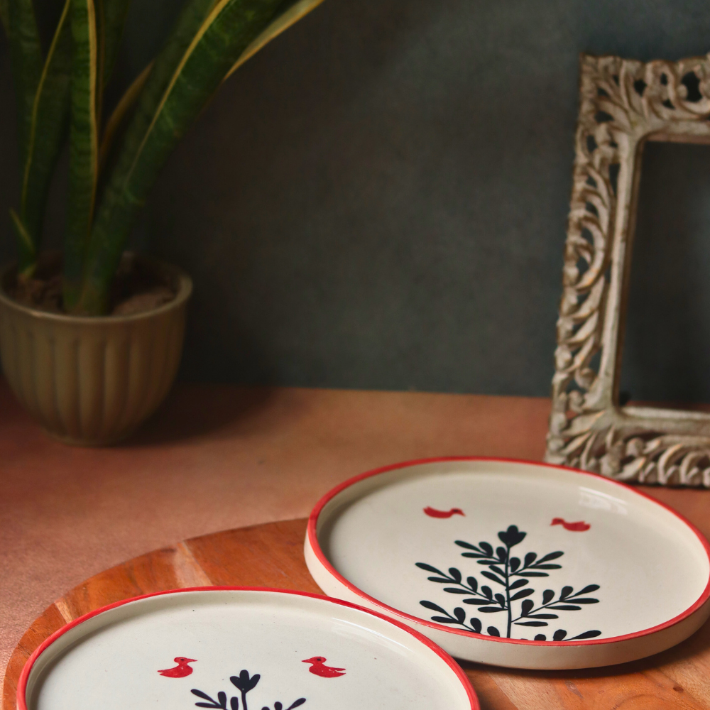 Two handmade ceramic platters birds & plant design