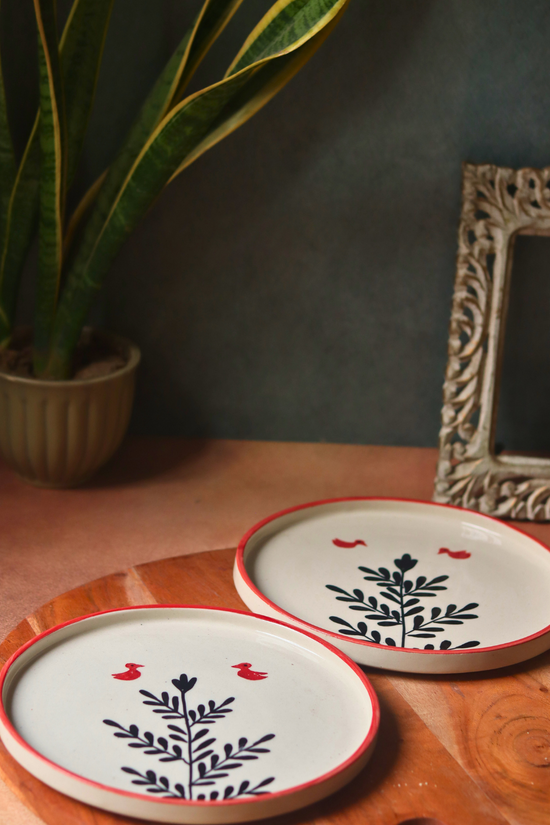 Two handmade ceramic platters birds & plant design
