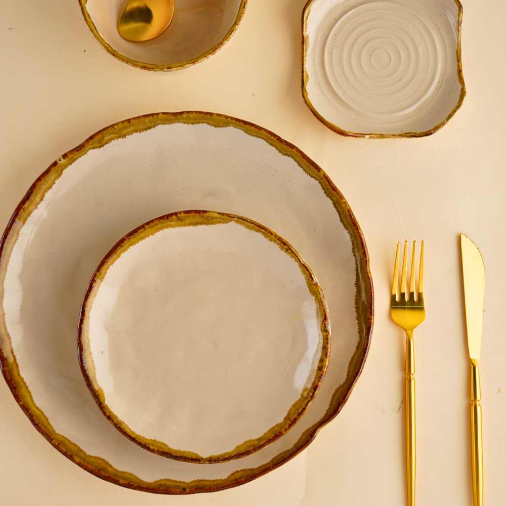 ivory stoneware dinner set with golden cutlery