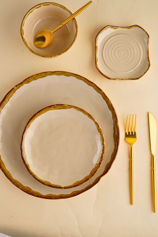 ivory stoneware dinner set with golden cutlery