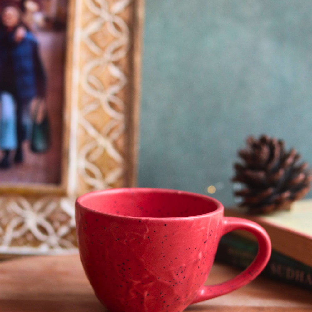 red textured mug made by ceramic 