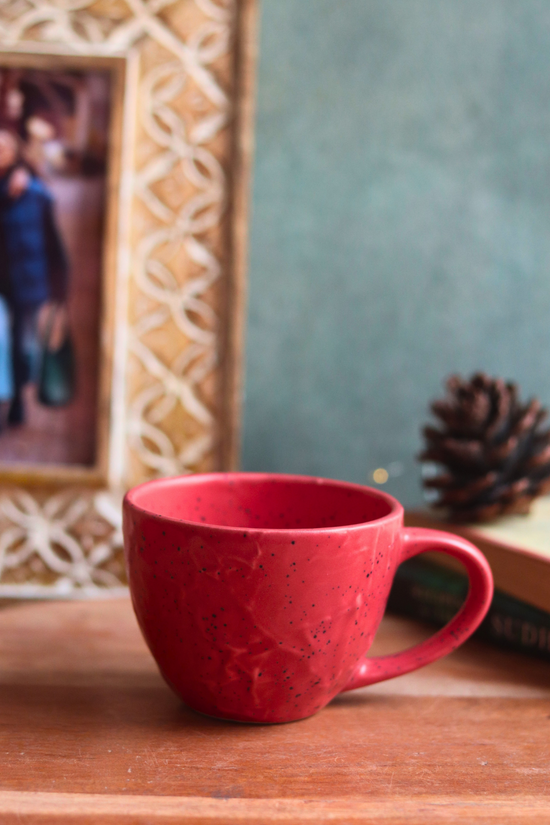 red textured mug made by ceramic 