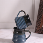 Dark blue & brown coffee mug on each other