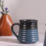 Dark blue coffee mug closeup shot