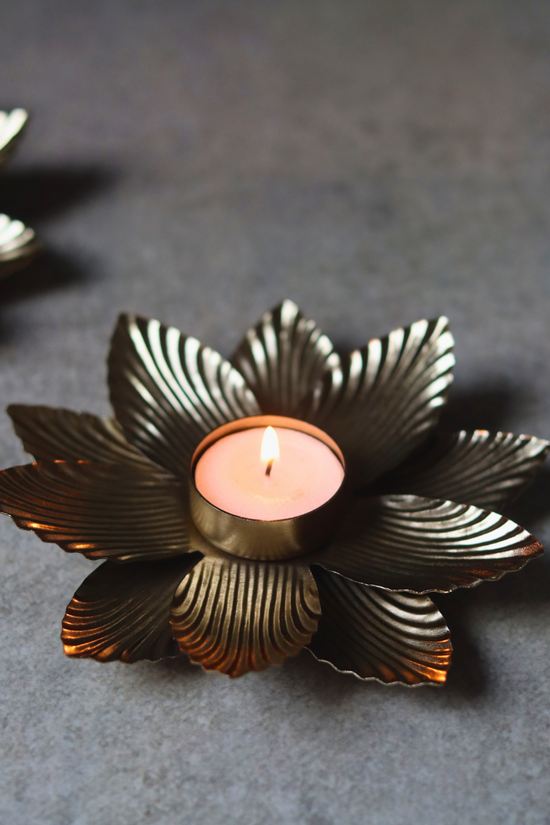 Golden flower tea light holder with candle