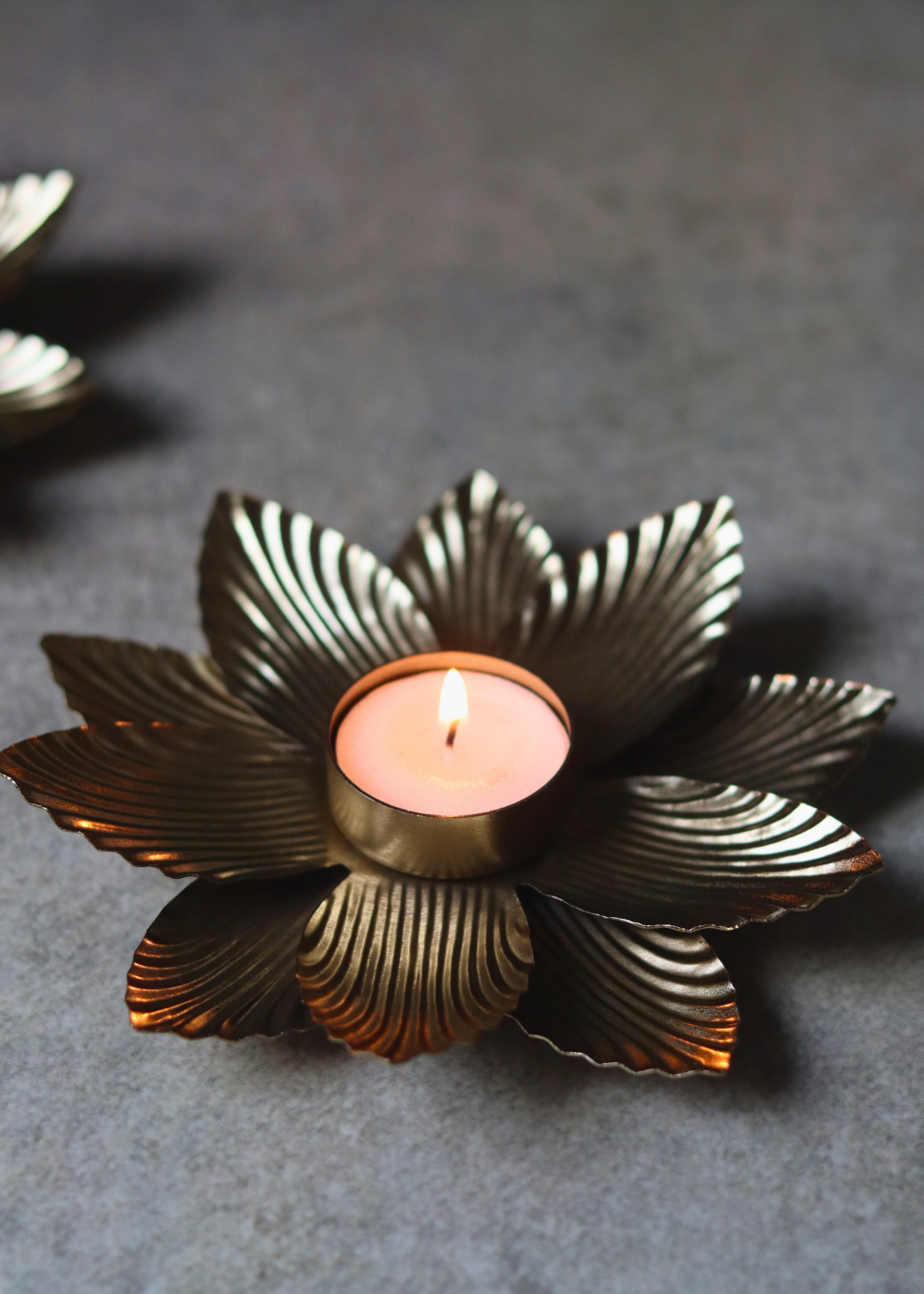 Golden flower tea light holder with candle