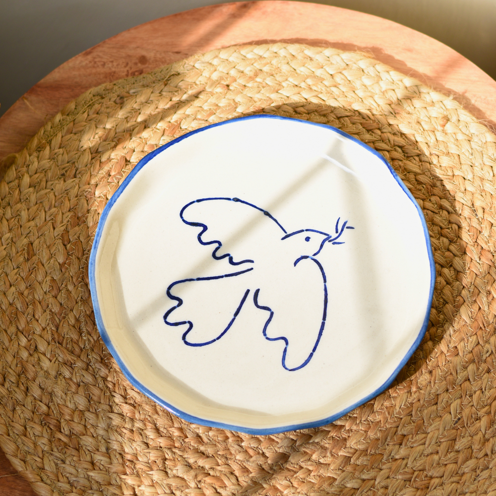 Birdie snack plate on a mat getting sunlight 