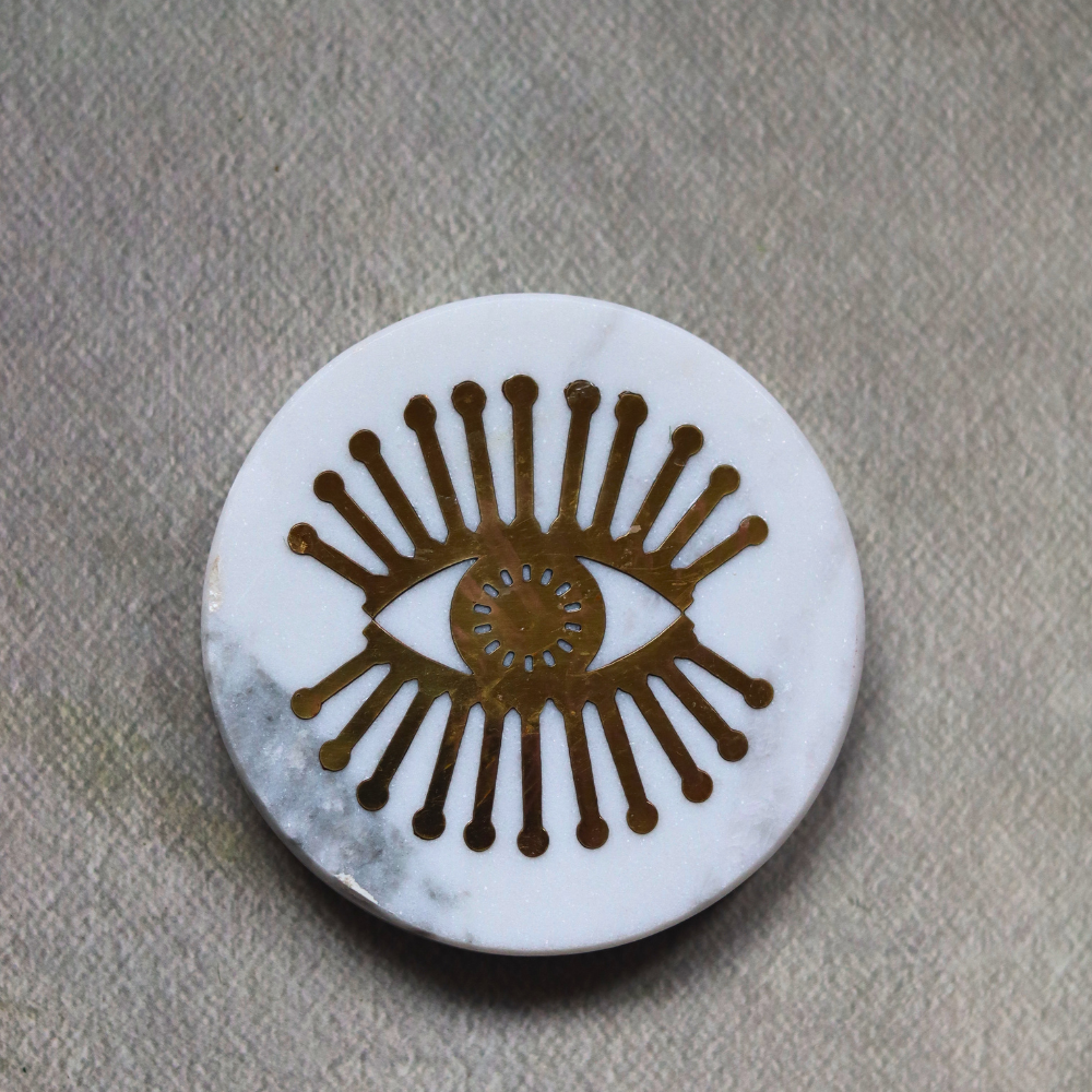 White marble with metal eye design coaster 