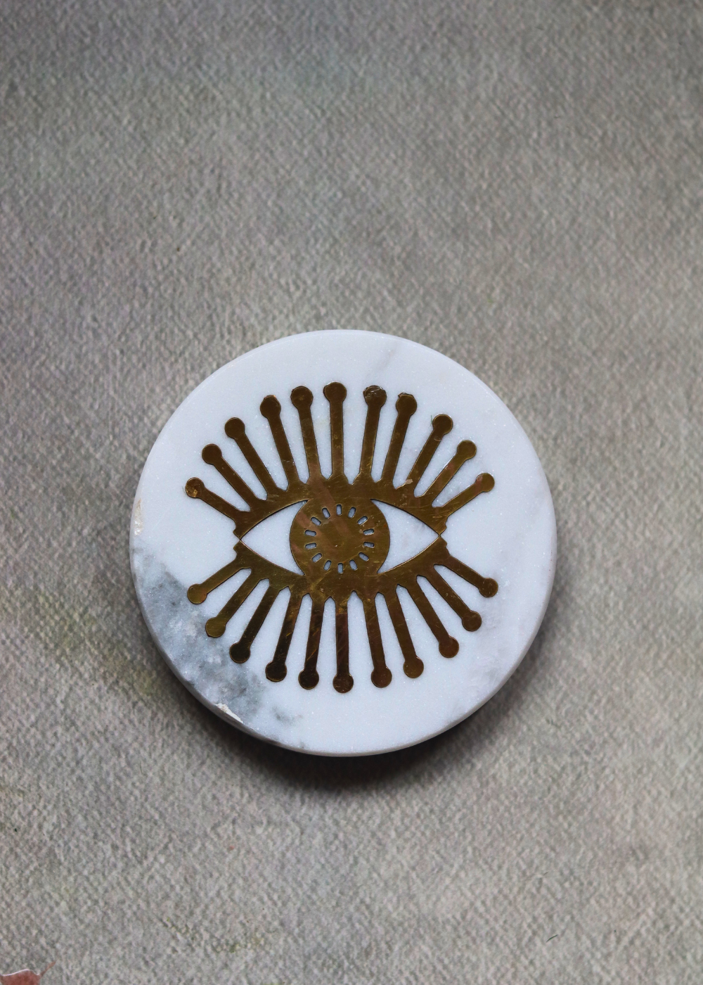 White marble with metal eye design coaster 