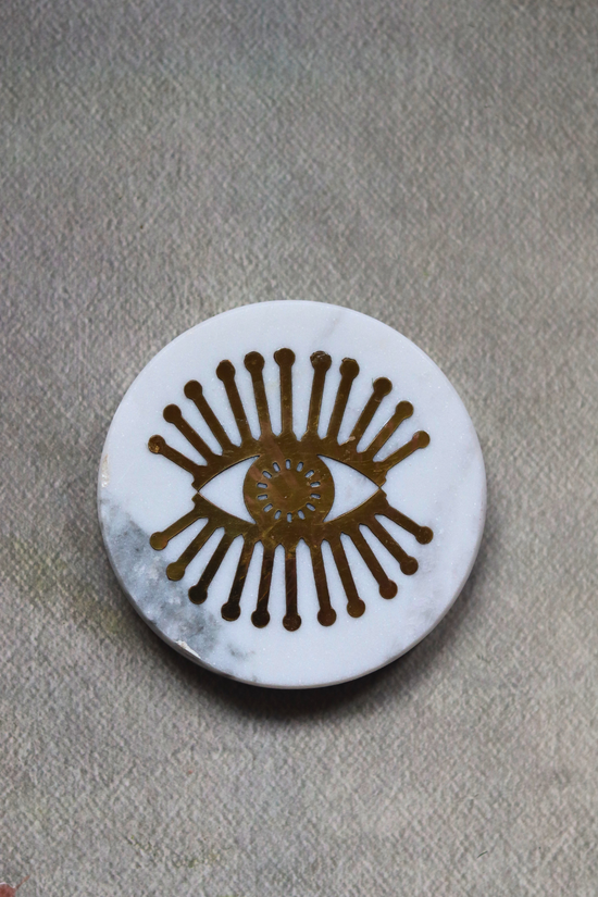 White marble with metal eye design coaster 