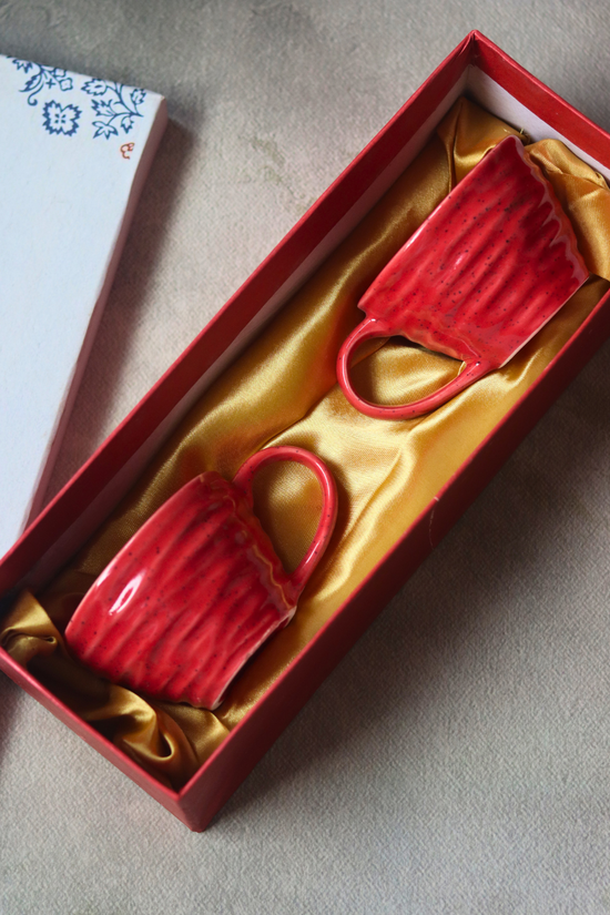 Two red coffee mugs in a gift box 