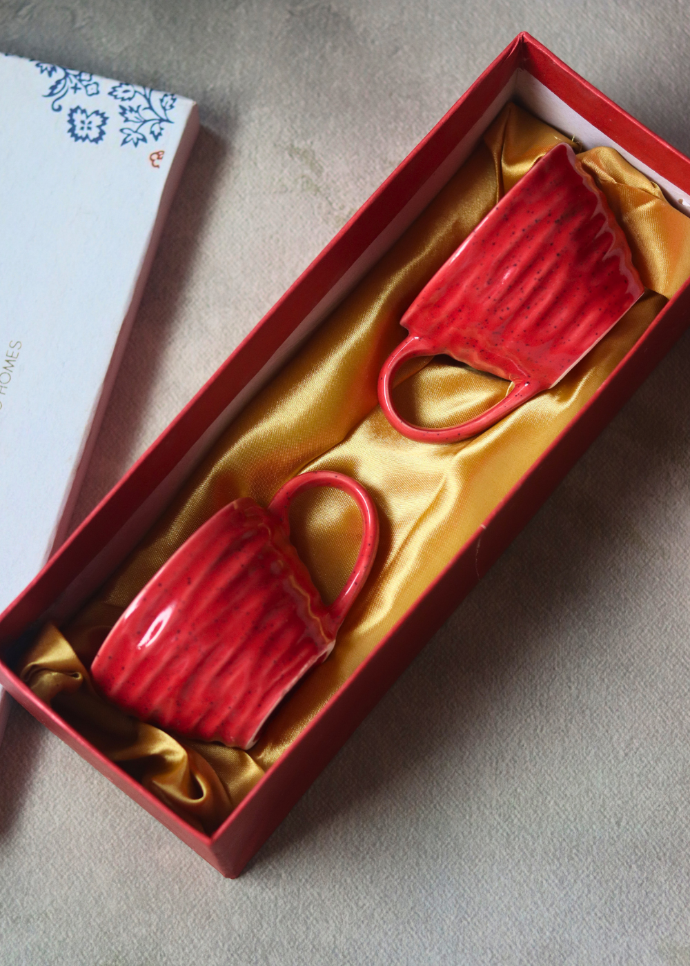 Two red coffee mugs in a gift box 
