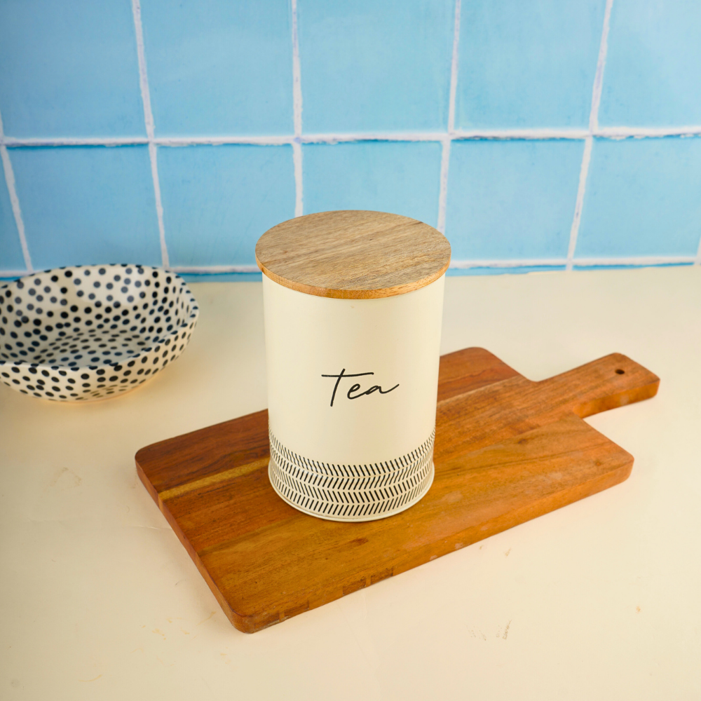 Ivory tea jar on wooden surface