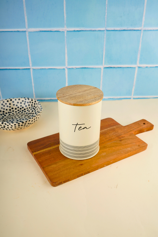 Ivory tea jar on wooden surface