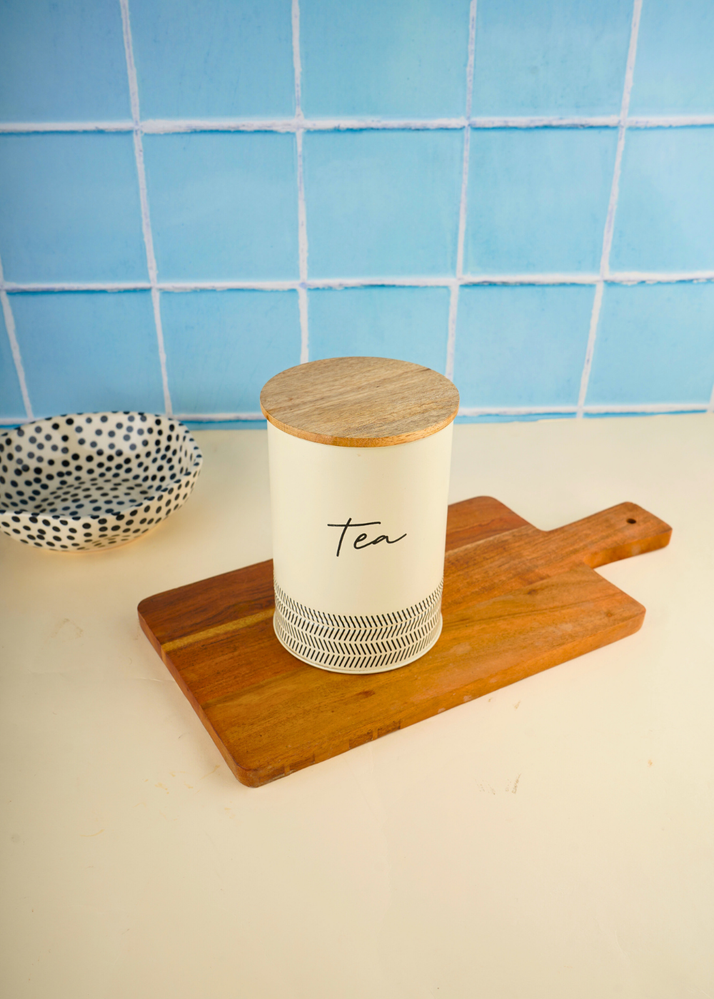 Ivory tea jar on wooden surface