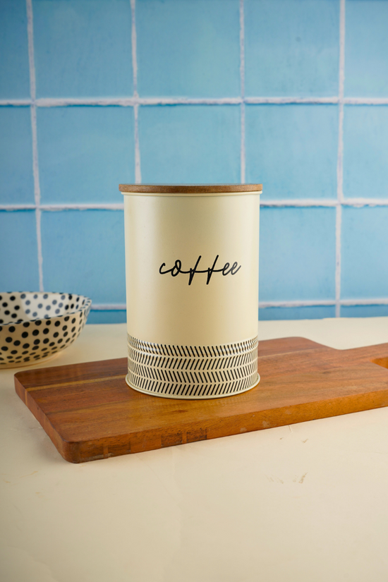 White & black coffee jar on wooden surface
