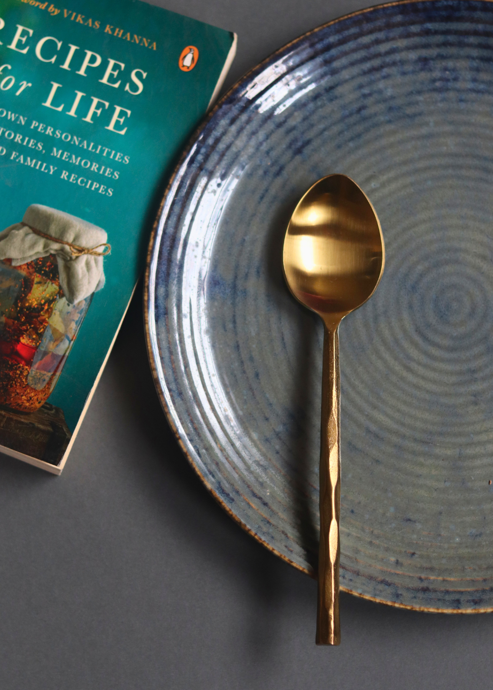 Gold hammered dinner spoon on plate