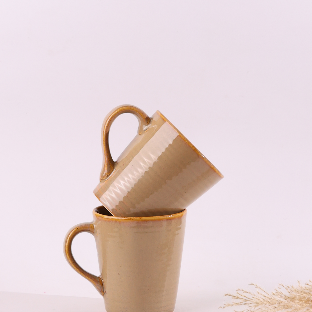 Ceramic cream coffee mugs on each other
