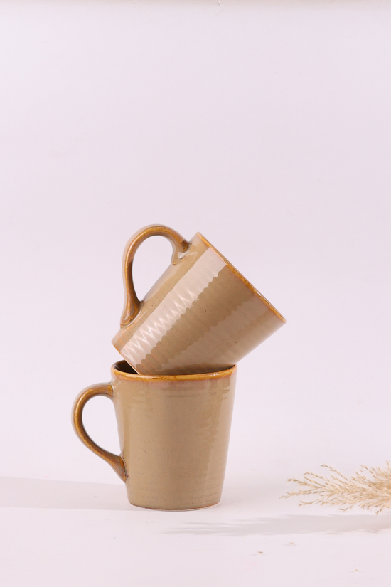 Ceramic cream coffee mugs on each other