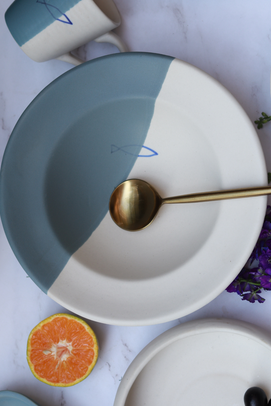 coastal catch pasta plate with golden spoon