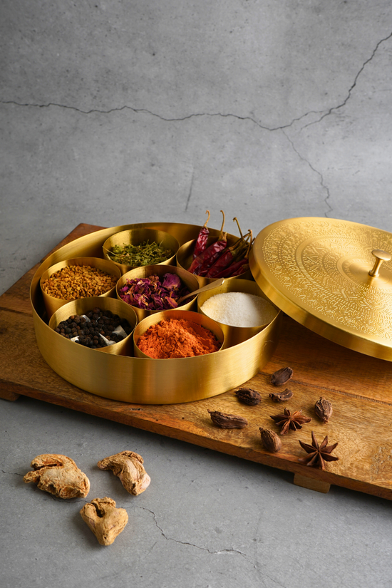 Brass spices box with spices in it
