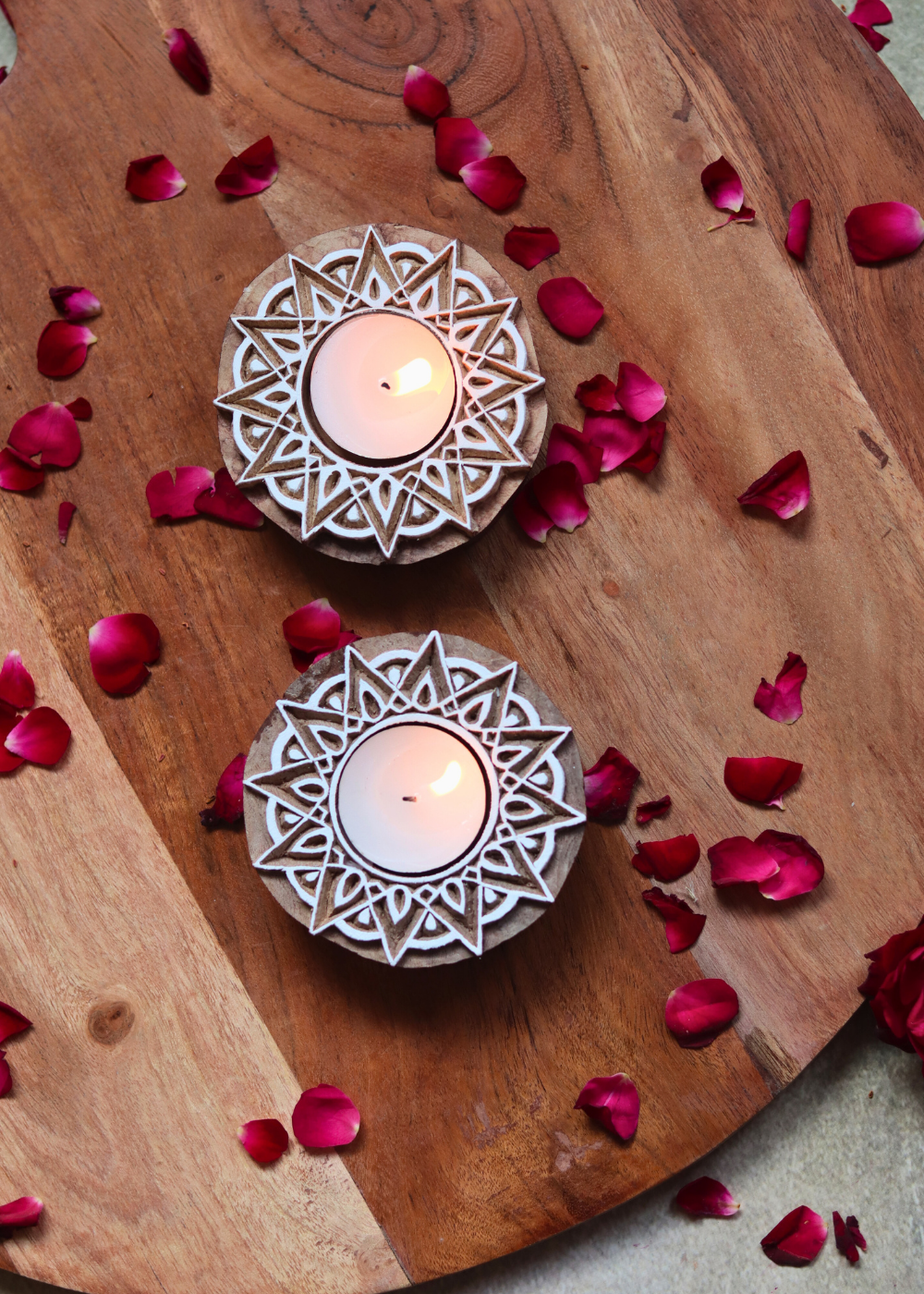 Wooden candle holders with flower petals 