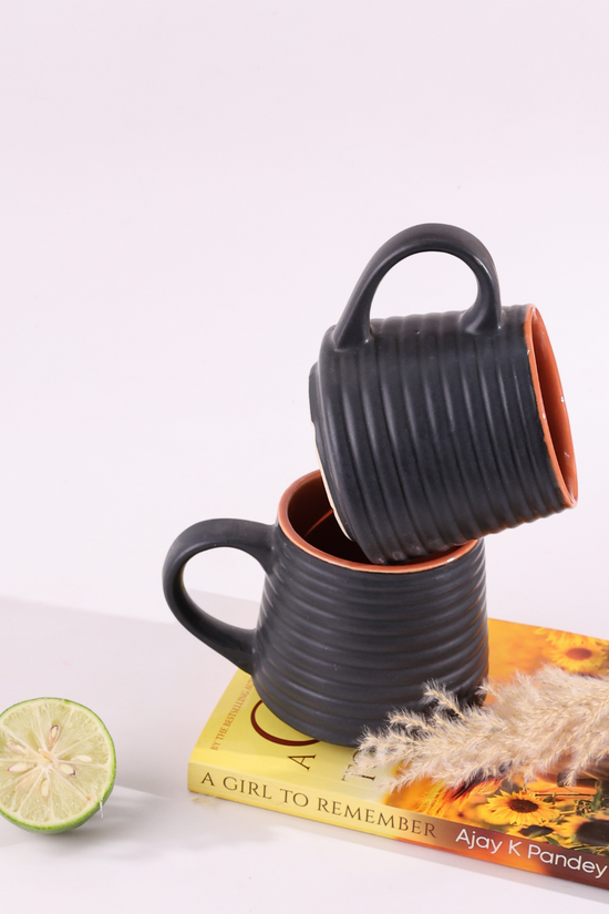 Two black ring coffee mug on book