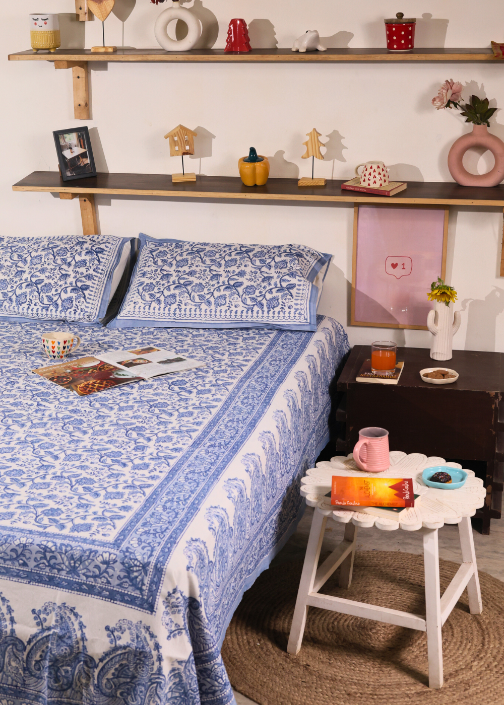 A systematic room & blue white bedsheet wit pillow