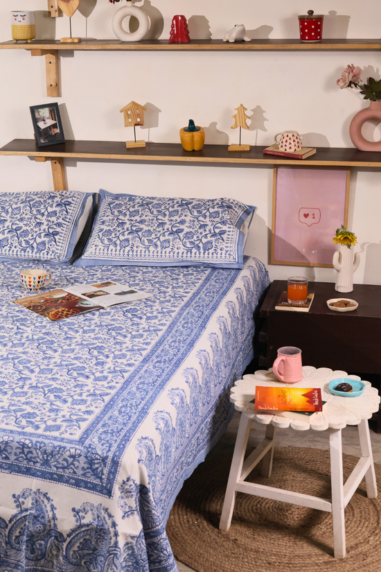 A systematic room & blue white bedsheet wit pillow