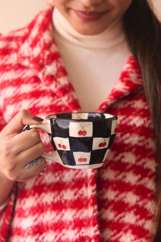 Ceramic cherry blossom coffee mug in hand 