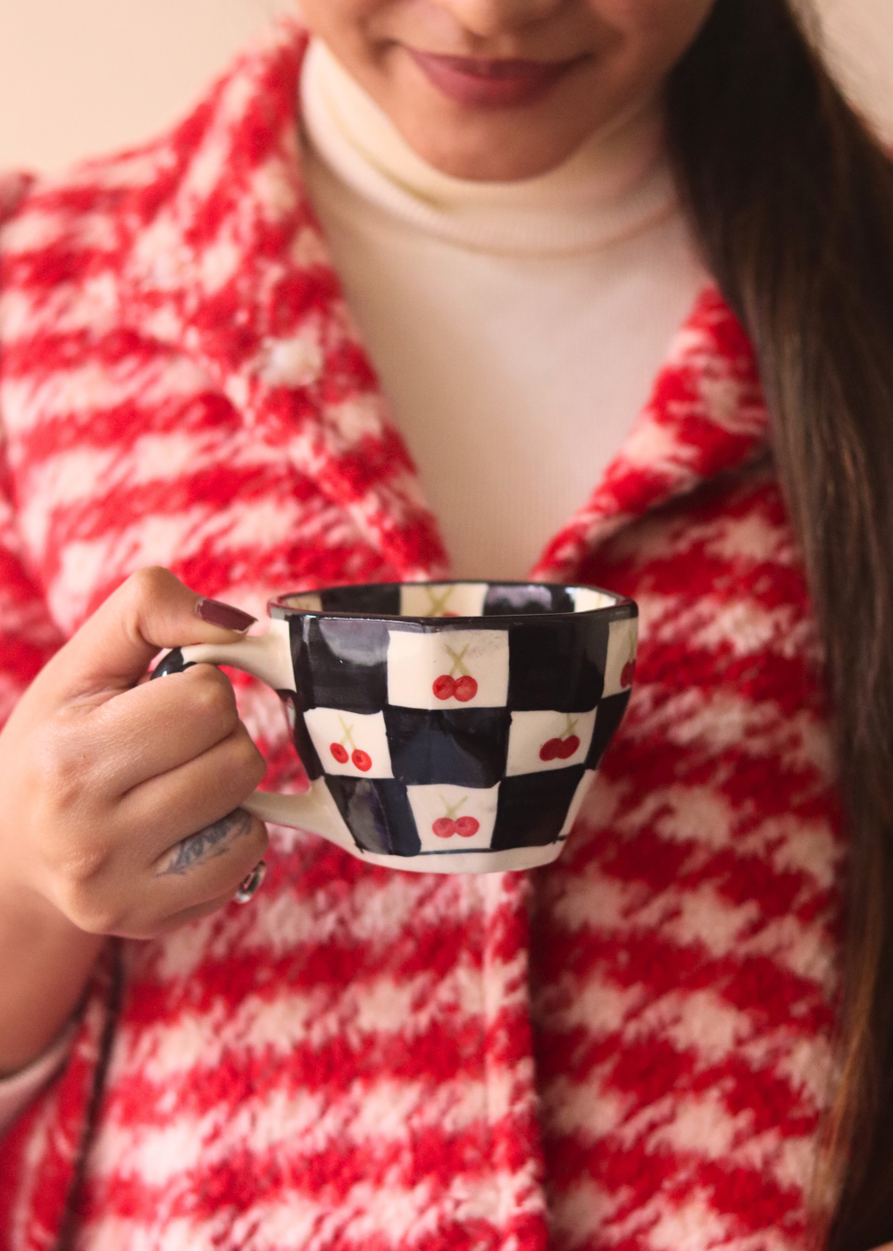 Ceramic cherry blossom coffee mug in hand 