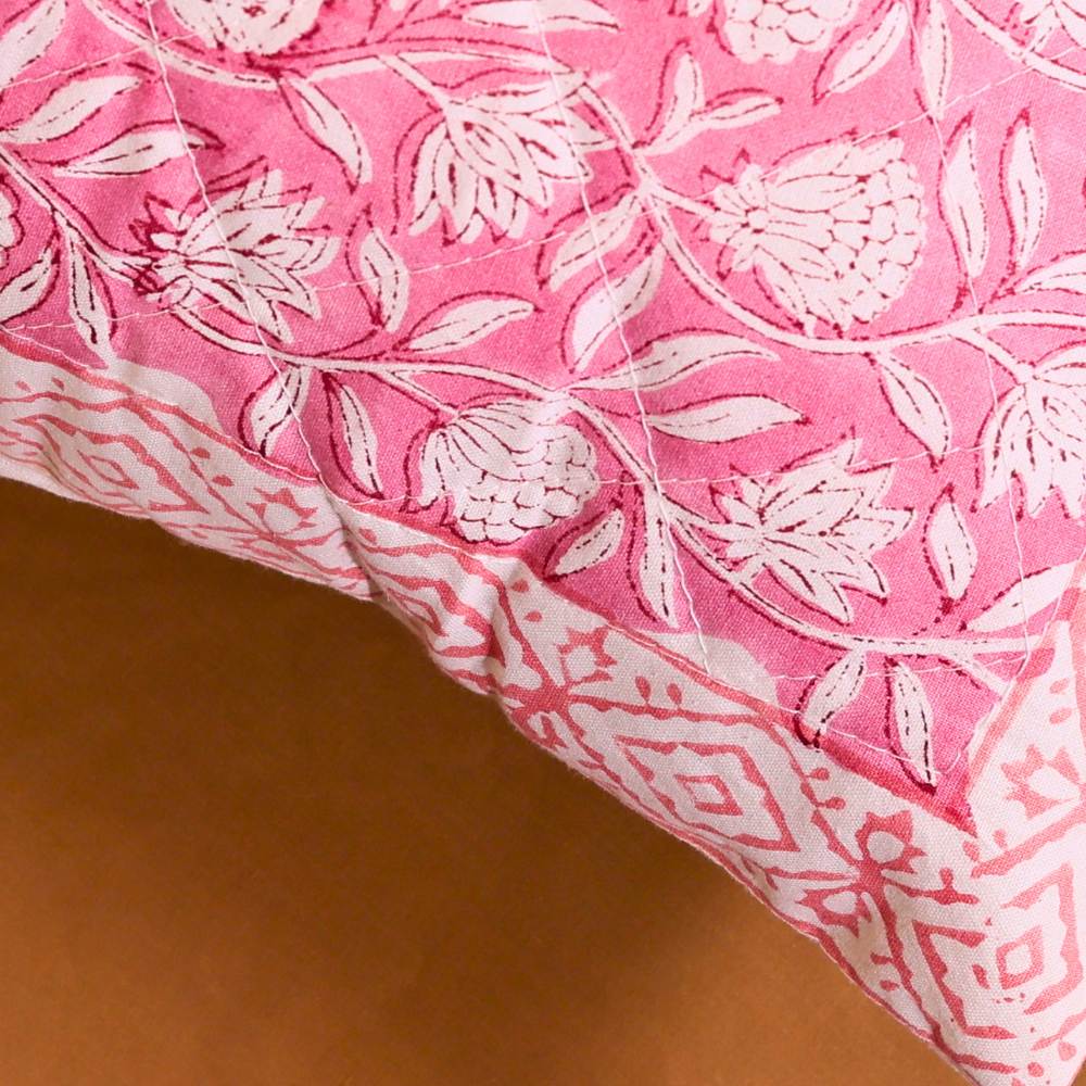Pink cushion cover with intricate design 