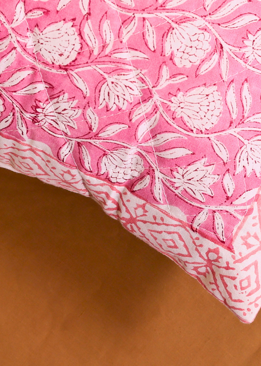 Pink cushion cover with intricate design 